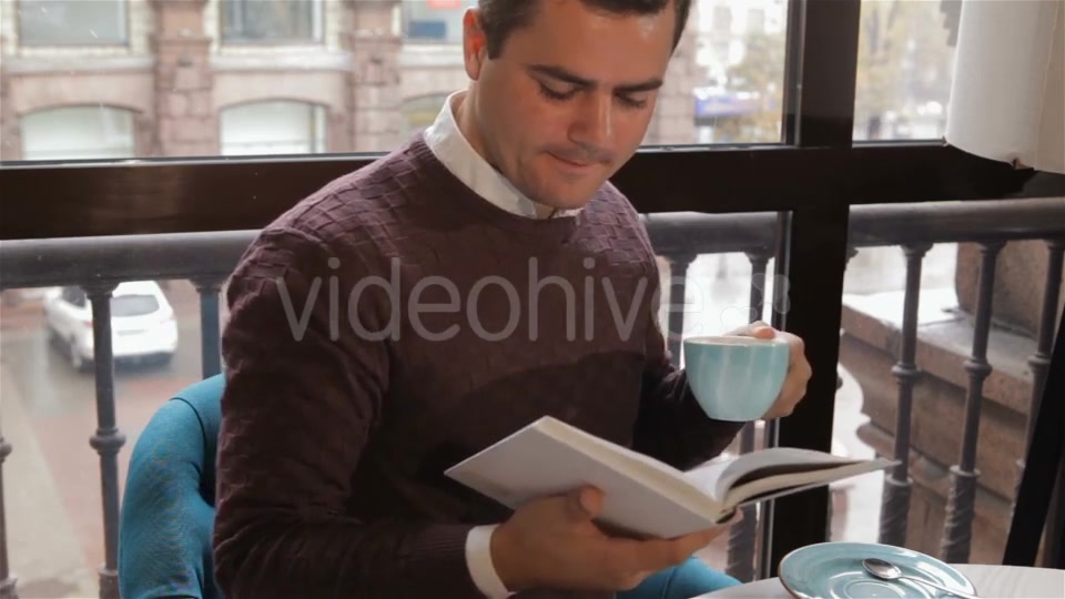 Man Reads Book At The Cafe - Download Videohive 18380237