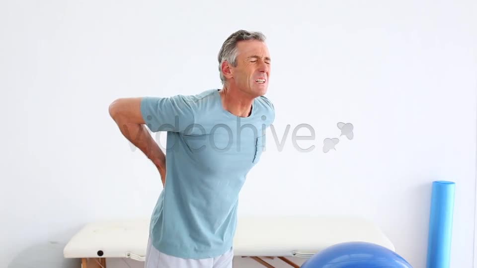 Mature Patient Rubbing His Painful Back  Videohive 8490996 Stock Footage Image 1