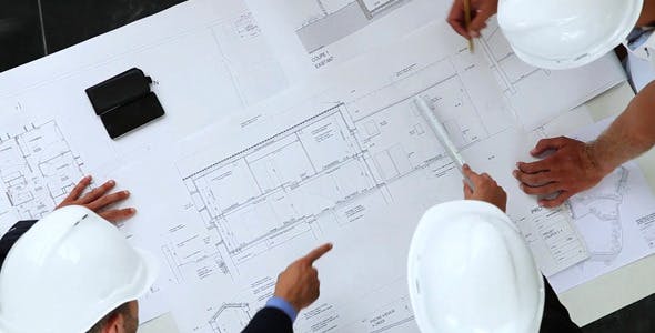 Young Architects Working On New Construction With Blueprints  - Download 8841017 Videohive