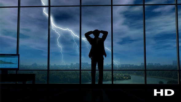 A Businessman Holds His Head When Thunder Clouds Gather Around Him - 20524349 Download Videohive