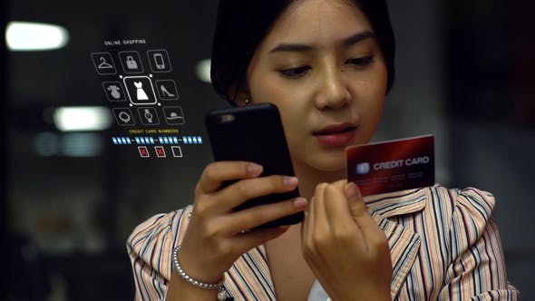 Asian Teenage Girl Using a Mobile Phone to Buy Online Products - Download Videohive 21879990